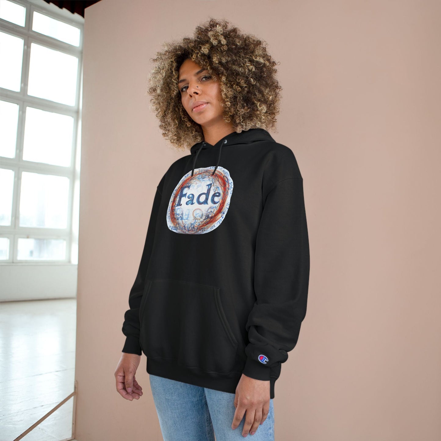 Black unisex hoodie with "Fade" graphic design, worn by a model. A bold and contemporary piece, perfect for casual and streetwear styles.