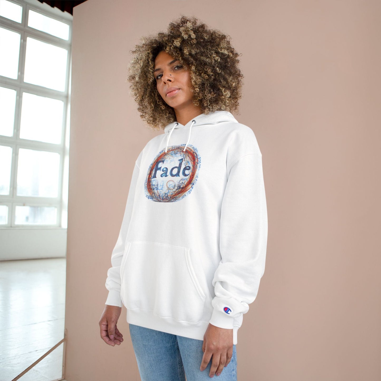 White unisex hoodie with "Fade" graphic design, worn by a model. A modern and bold piece, perfect for casual or streetwear styles.