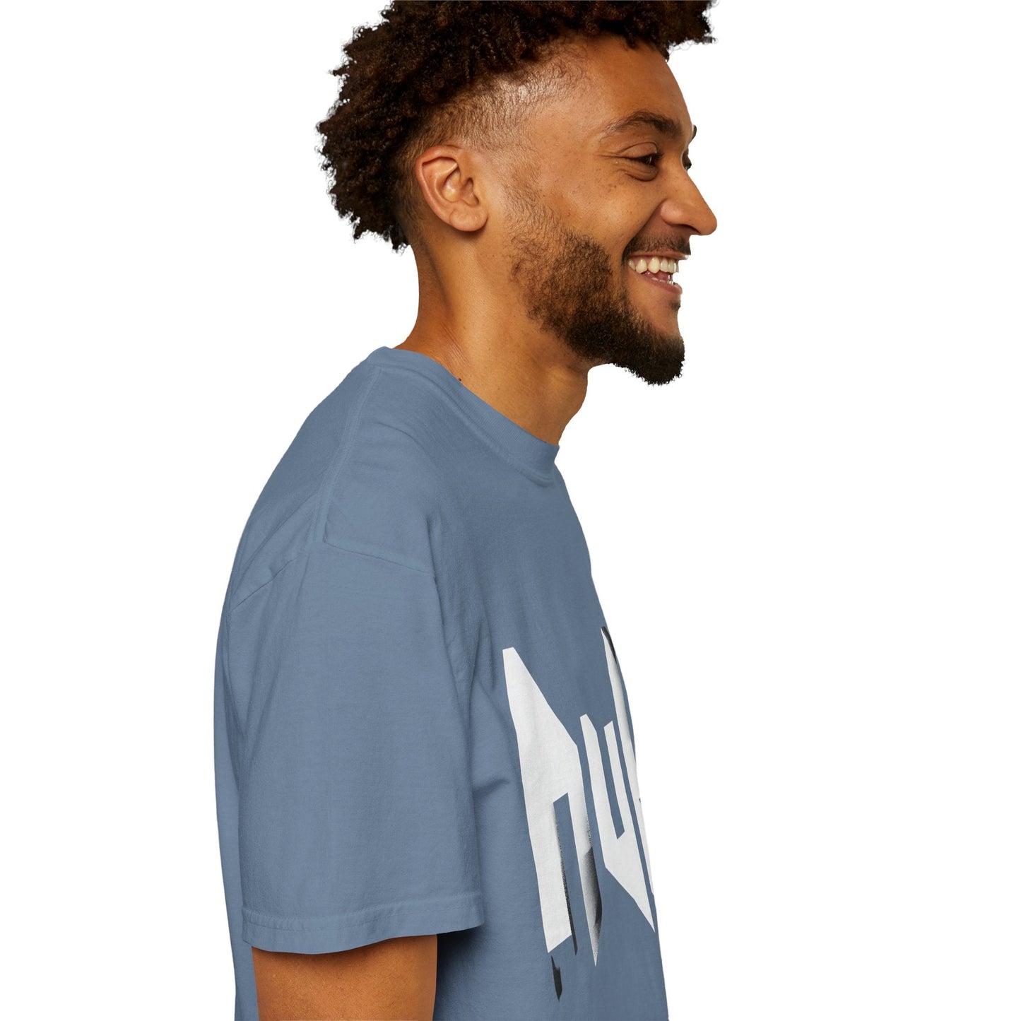 Side view of man wearing blue unisex T-shirt with angular white "null" graphic—modern minimalist design for casual streetwear.