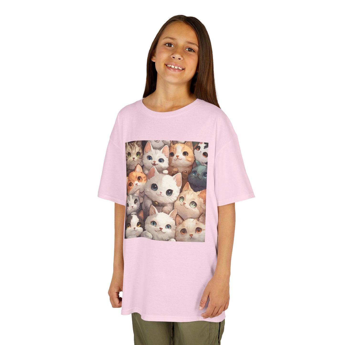 A young girl standing facing forward, wearing a Light Pink T-shirt featuring a charming design with an abundance of adorable cats.