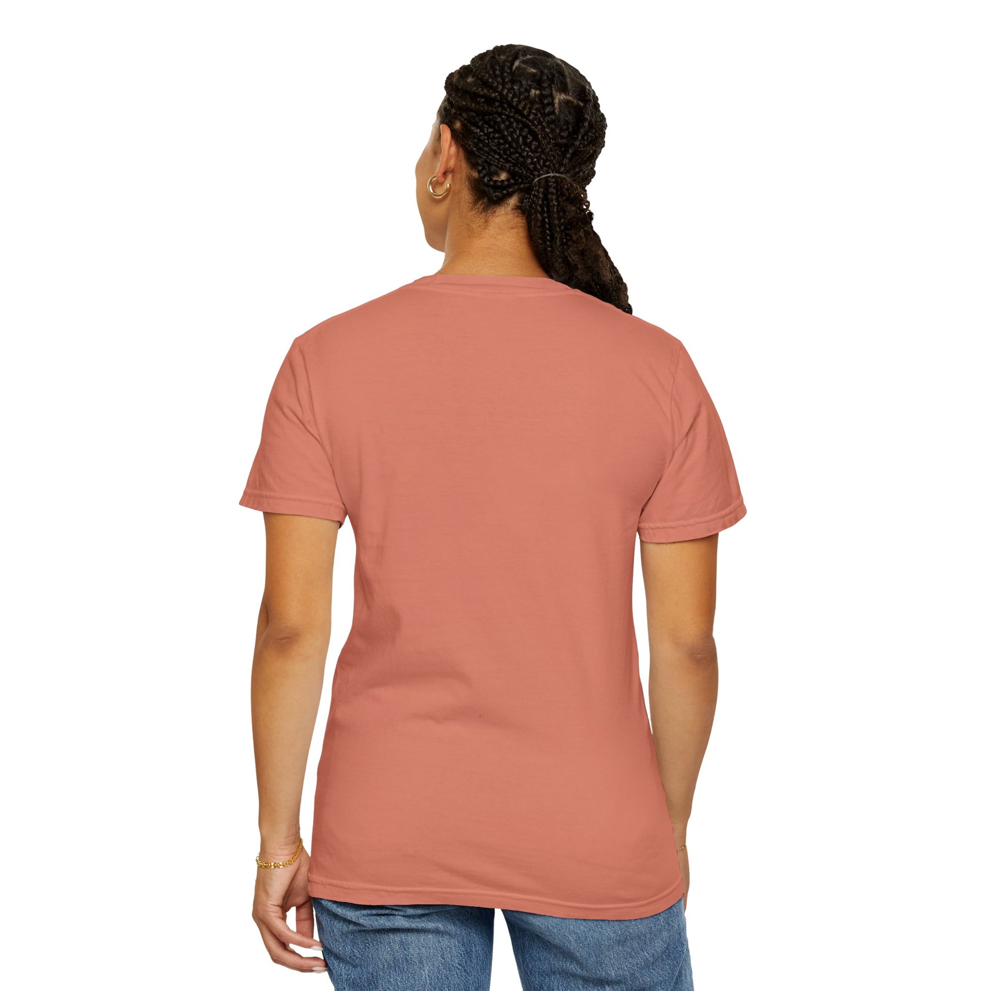 A woman facing away while wearing a terracotta T-shirt featuring an enchanting abstract design and refined typography.