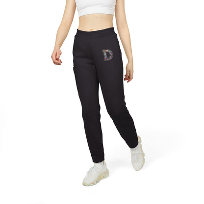 A slim woman wearing Black joggers featuring a bold "D" design on the front with a retro-futuristic and holographic vibe.