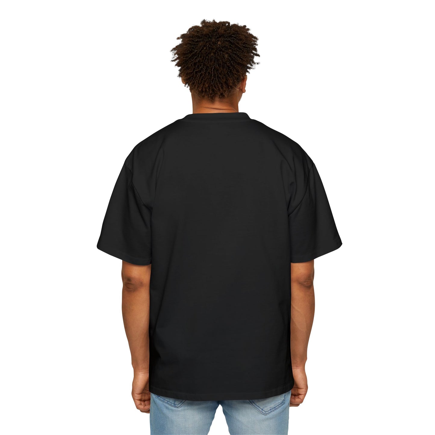 The back view of a man standing and wearing an oversized Black T-shirt.
