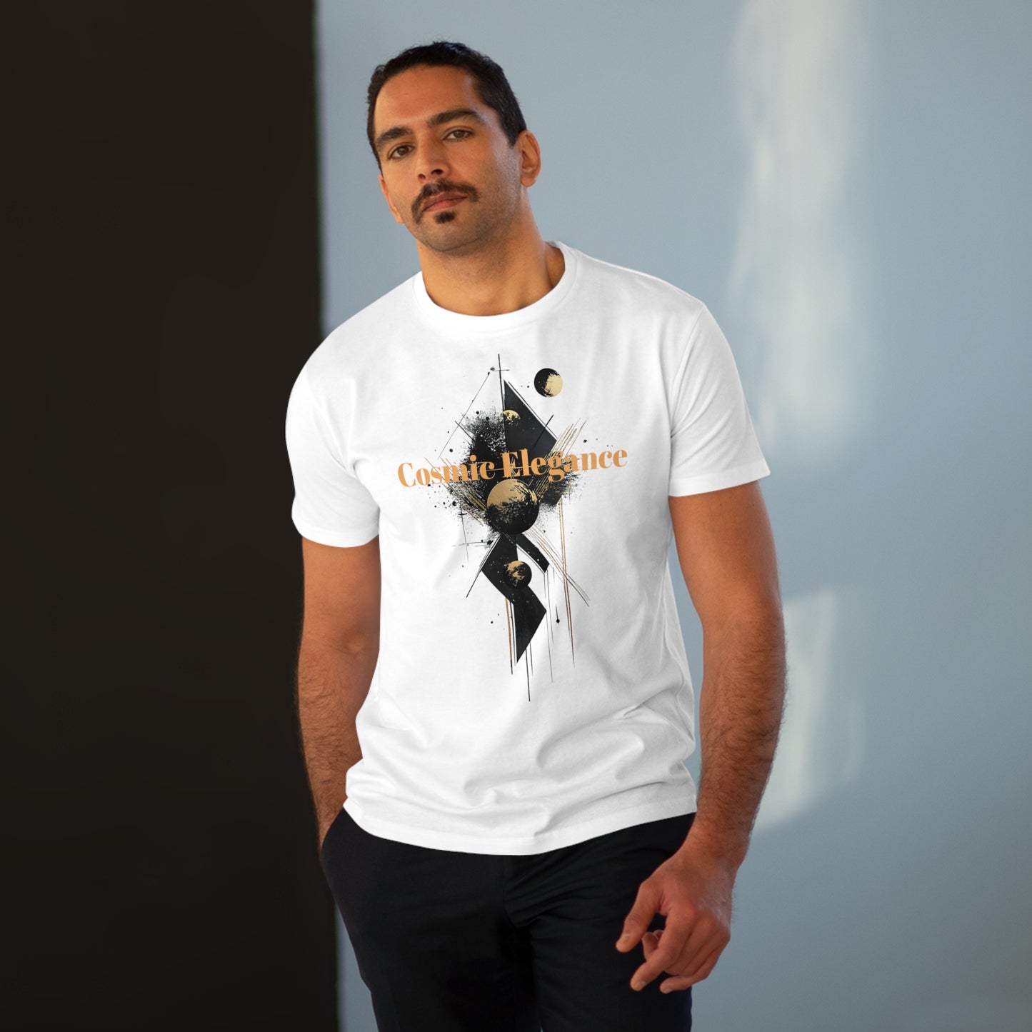 A man wearing a white T-shirt featuring the design of cosmic elegance, with abstract planetary elements, smooth geometric shapes, and celestial aesthetics.