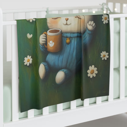 A charmingly designed blanket featuring a relaxed kitten enjoying a peaceful moment is draped over a baby crib.