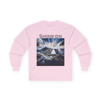 A light pink T-shirt adorned with a vibrant diamond design in blue, pink, and black.