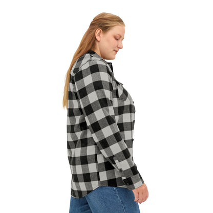 A woman facing right, wearing a classic black-and-white buffalo plaid flannel shirt that blends ruggedness with style.