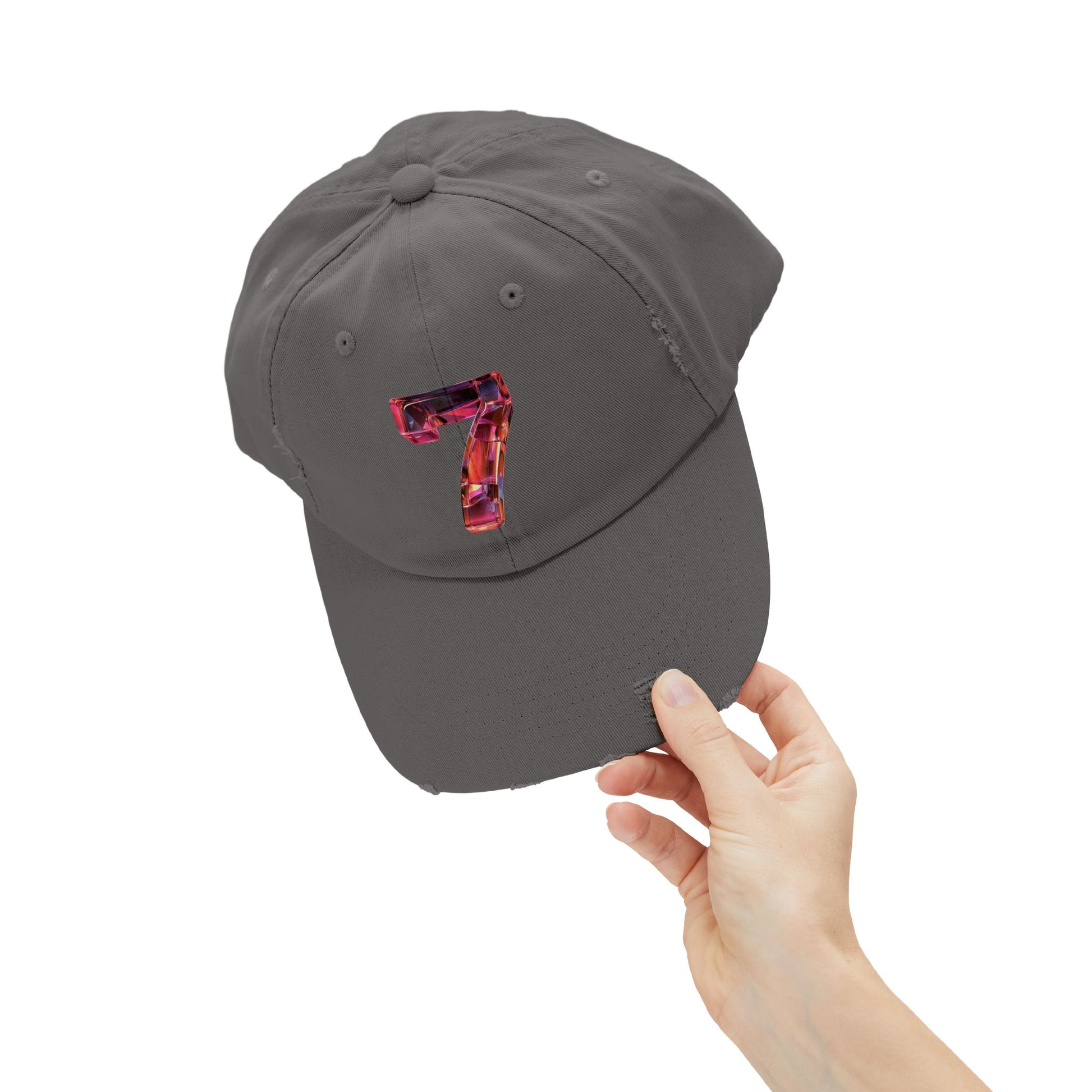 Holding the brim of a distressed Nickel cap featuring a unique and modern design with a 3D image of the number "7" in a transparent glass style.
