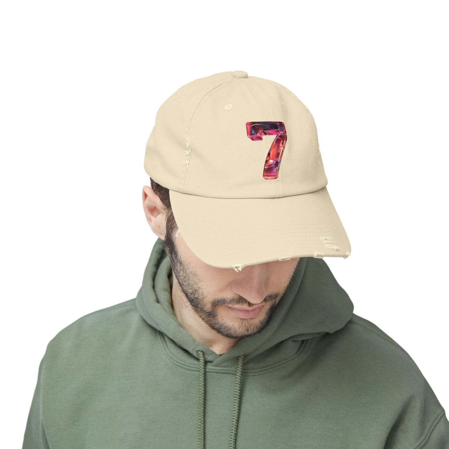 A man looking down while wearing a distressed Stone cap featuring a unique and modern design with a 3D image of the number "7" in a transparent glass style.