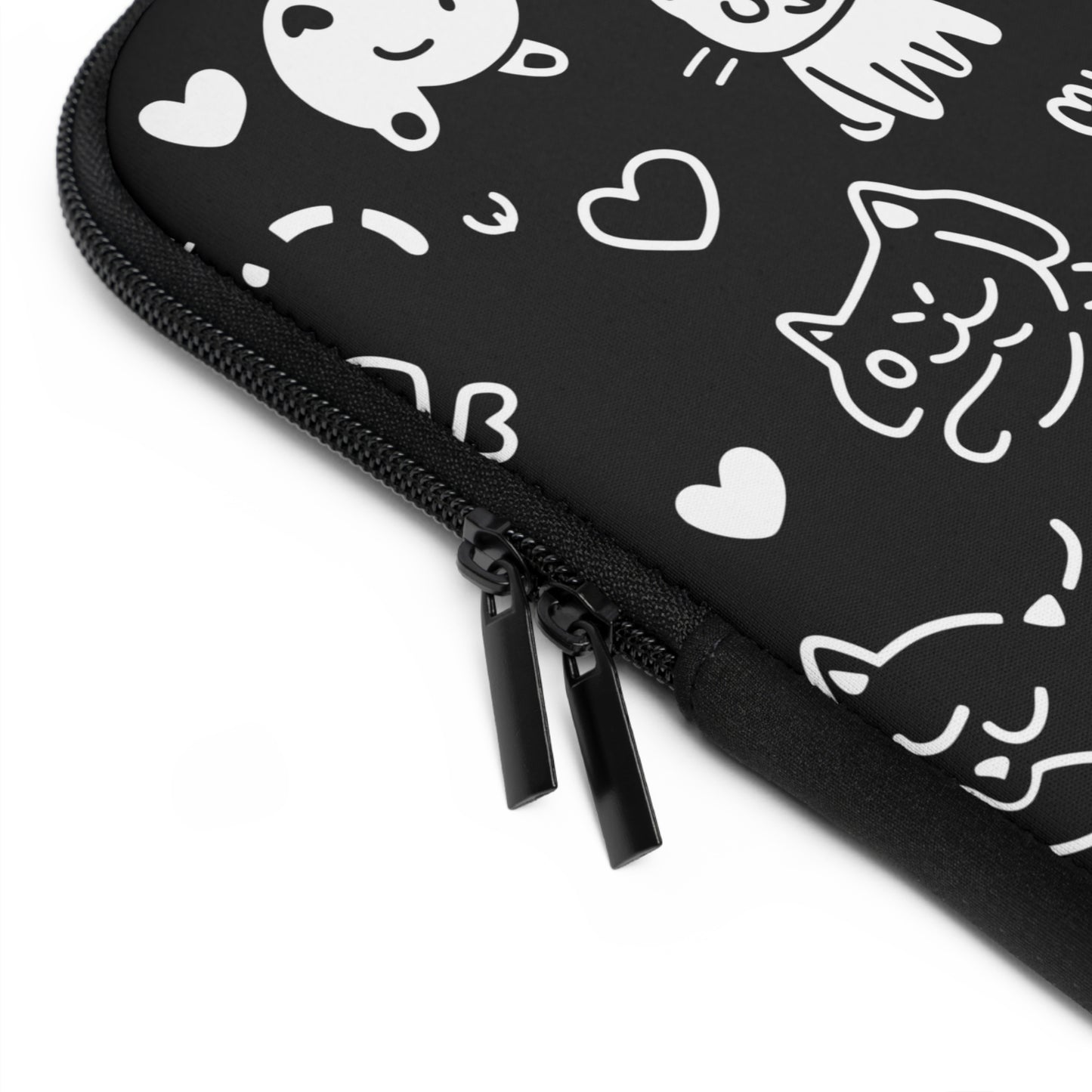 A close-up of the zipper on a laptop sleeve featuring an adorable cat pattern.