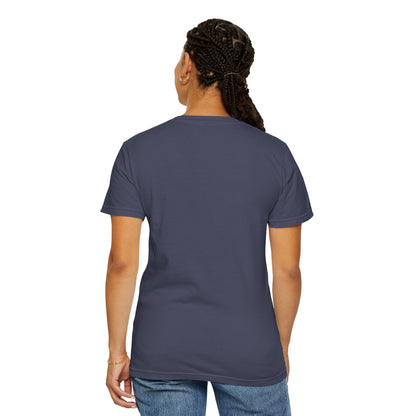 A woman standing with her back turned, wearing a Denim T-shirt.