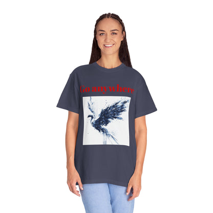 A long-haired woman standing facing forward, wearing a unisex Denim garment-dyed T-shirt featuring glitch art depicting a majestic phoenix rising, fragmented in navy and white digital distortion.