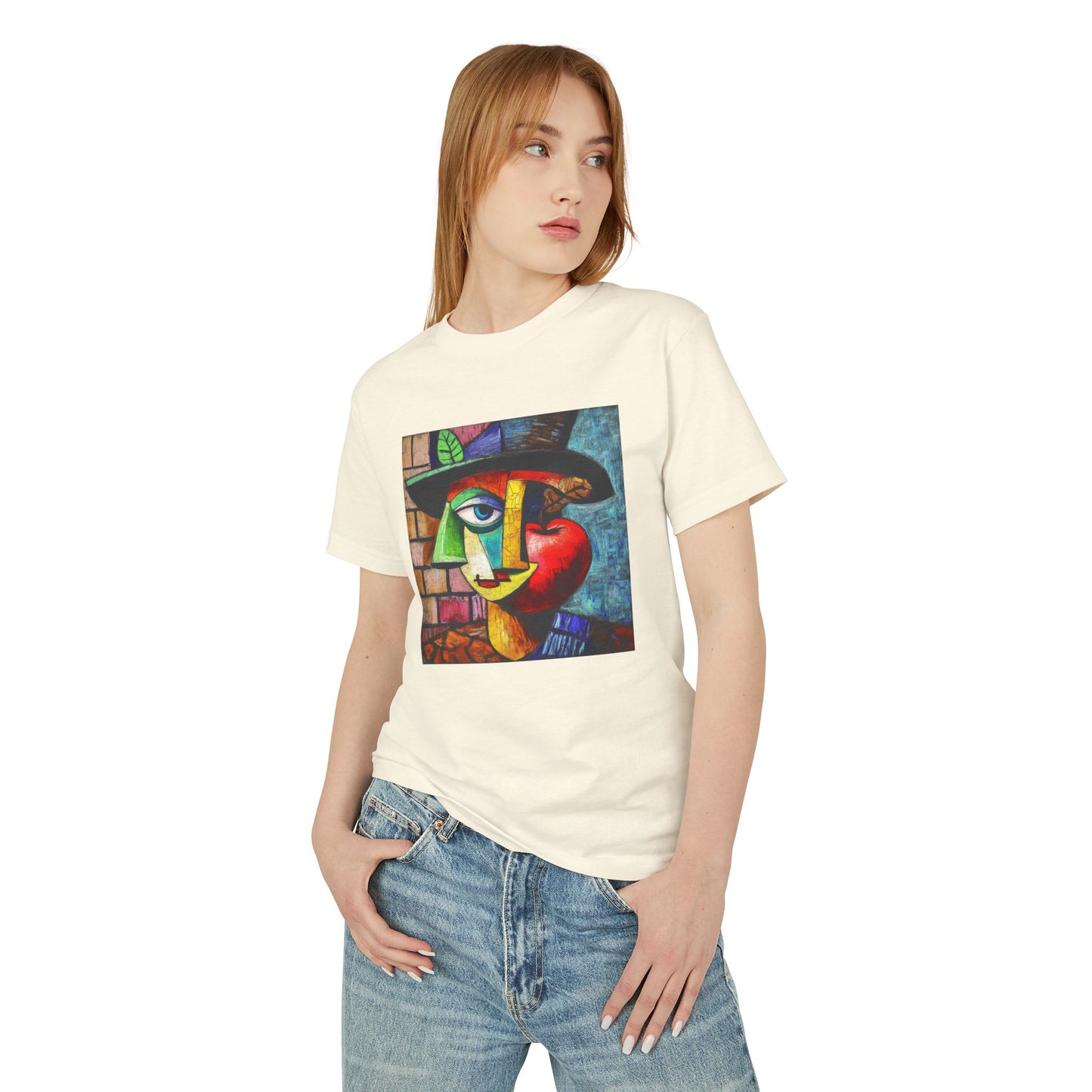 A blonde woman standing and wearing a Faded Cream unisex vintage T-shirt featuring an artistic design with the charm of "Picasso painted an apple."