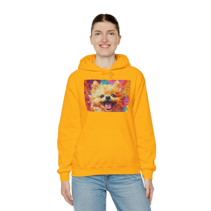 A woman standing in a Gold hoodie featuring vibrant Pomeranian dog artwork in an acrylic style.