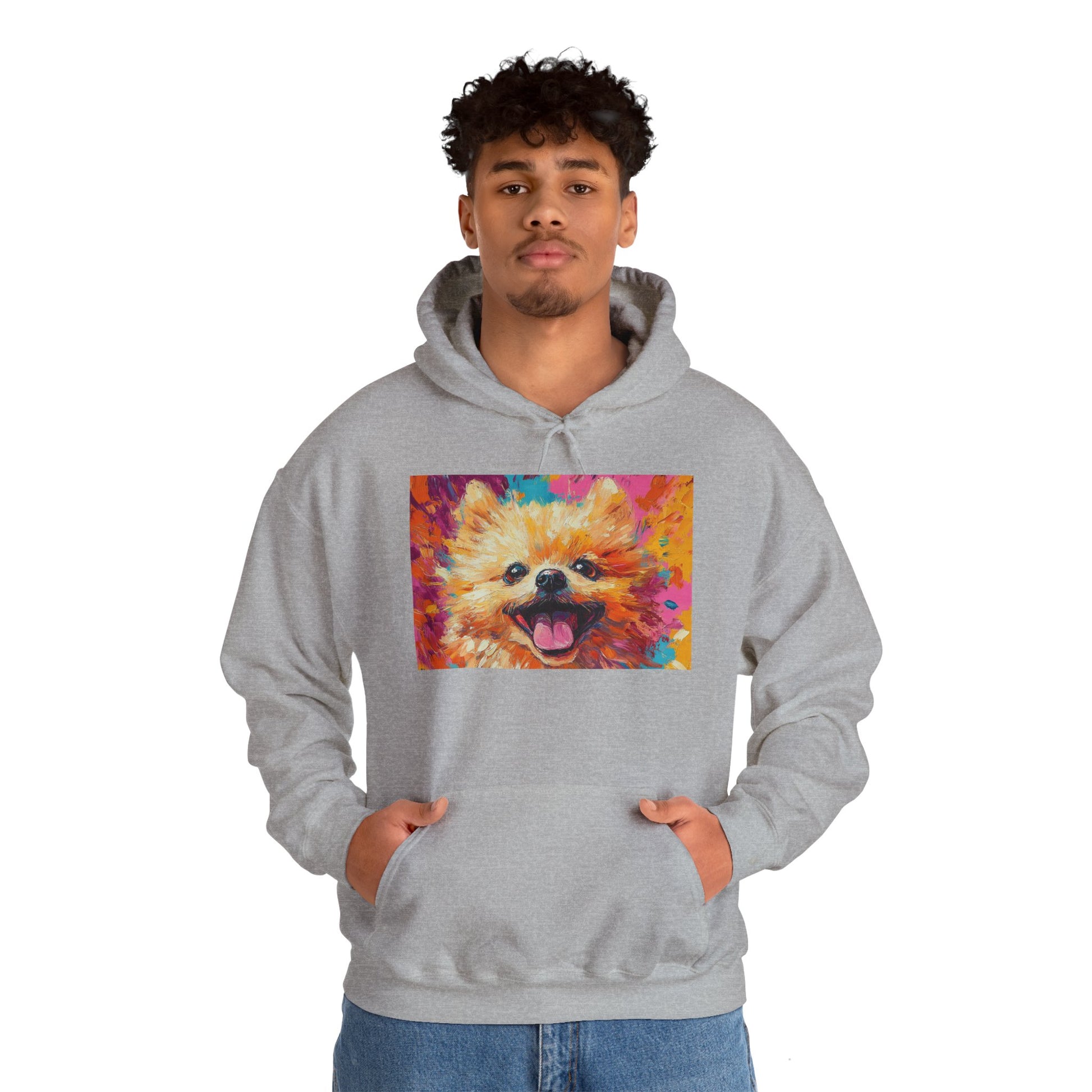 A man wearing a Sport Grey hoodie with a vivid acrylic-style artwork of a Pomeranian dog, hands in his pockets.

