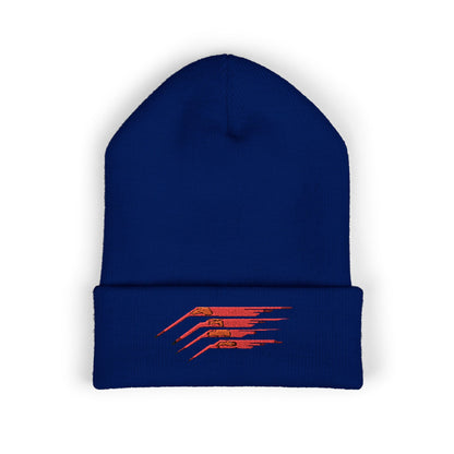 A royal blue beanie featuring an energetic red speed line design on a sleek black base.