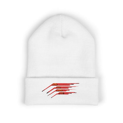 A white beanie featuring an energetic red speed line design on a sleek black base.