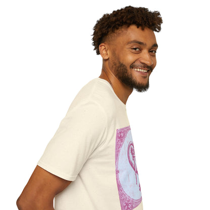 A man facing right and smiling, wearing a Natural T-shirt featuring a vintage 1980s tarot card design with pink risograph and bold gothic typography.
