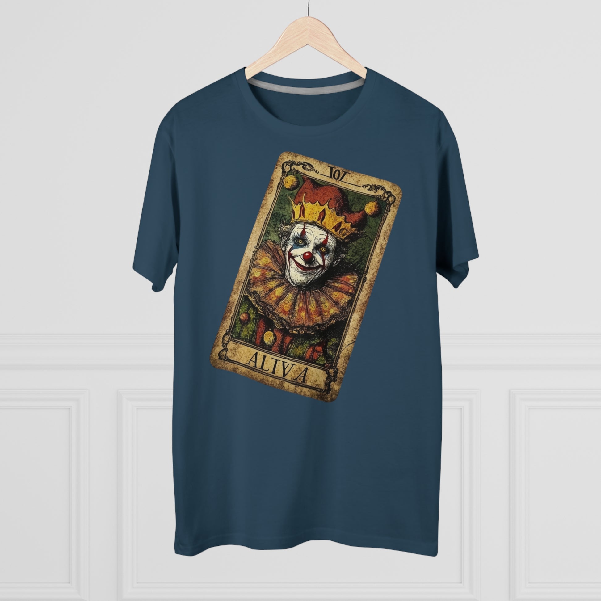 A Denim T-shirt with a unique Tarot card design featuring a clown against a dark grunge-style background, hung on a hanger facing forward.
