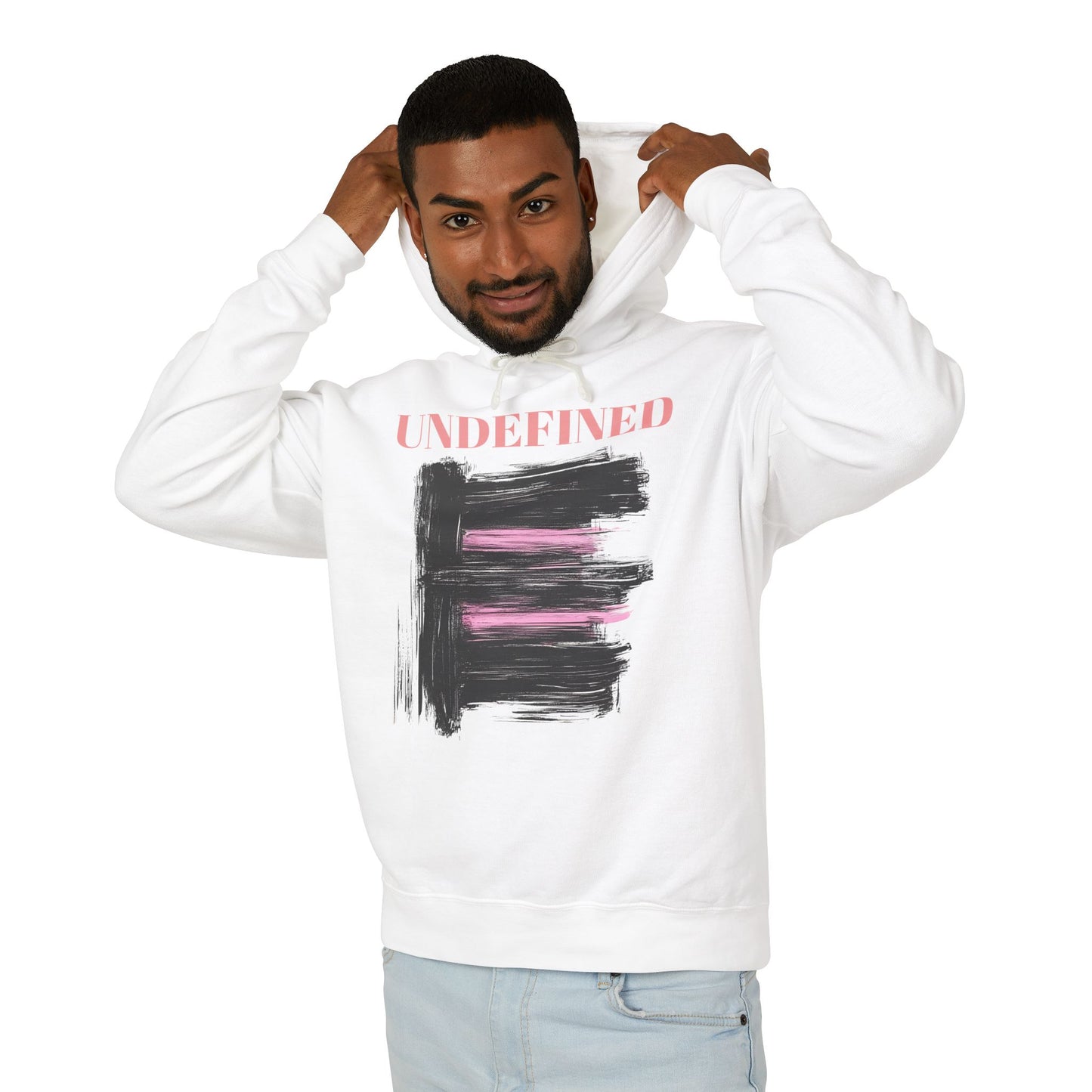 A man wearing a white hoodie featuring bold black brushstrokes with subtle pink accents, enhancing its modern and artistic vibe.