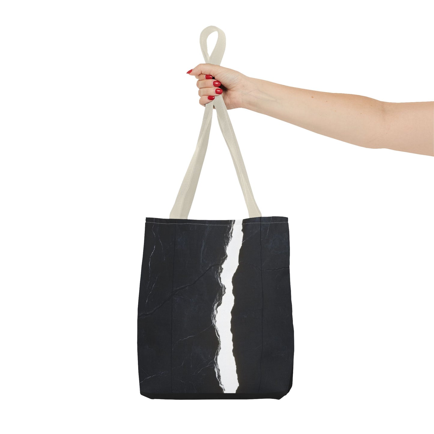 Holding a Beige-handled tote bag with a massive black wall, white cracks, light streaming through, and a central black vertical rock.
