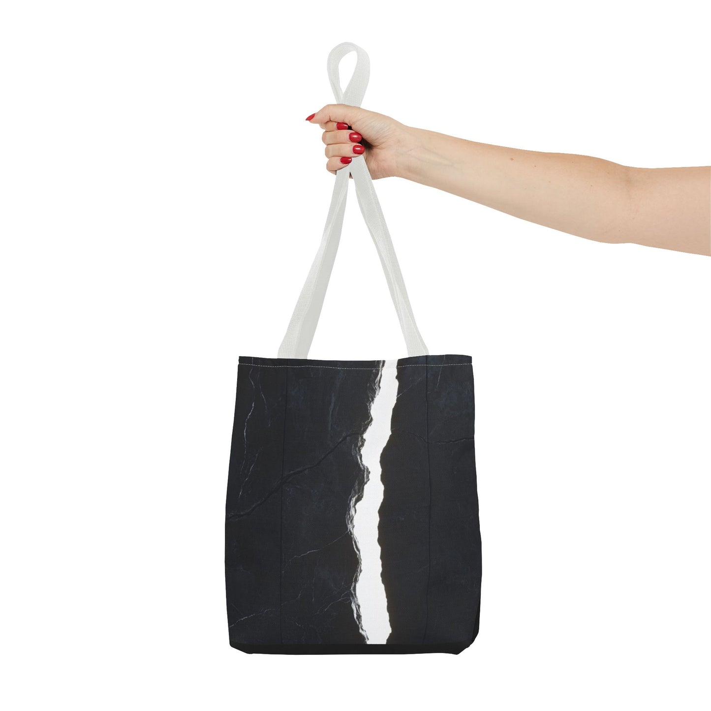 Holding a White-handled tote bag with a massive black wall, white cracks, light streaming through, and a central black vertical rock.