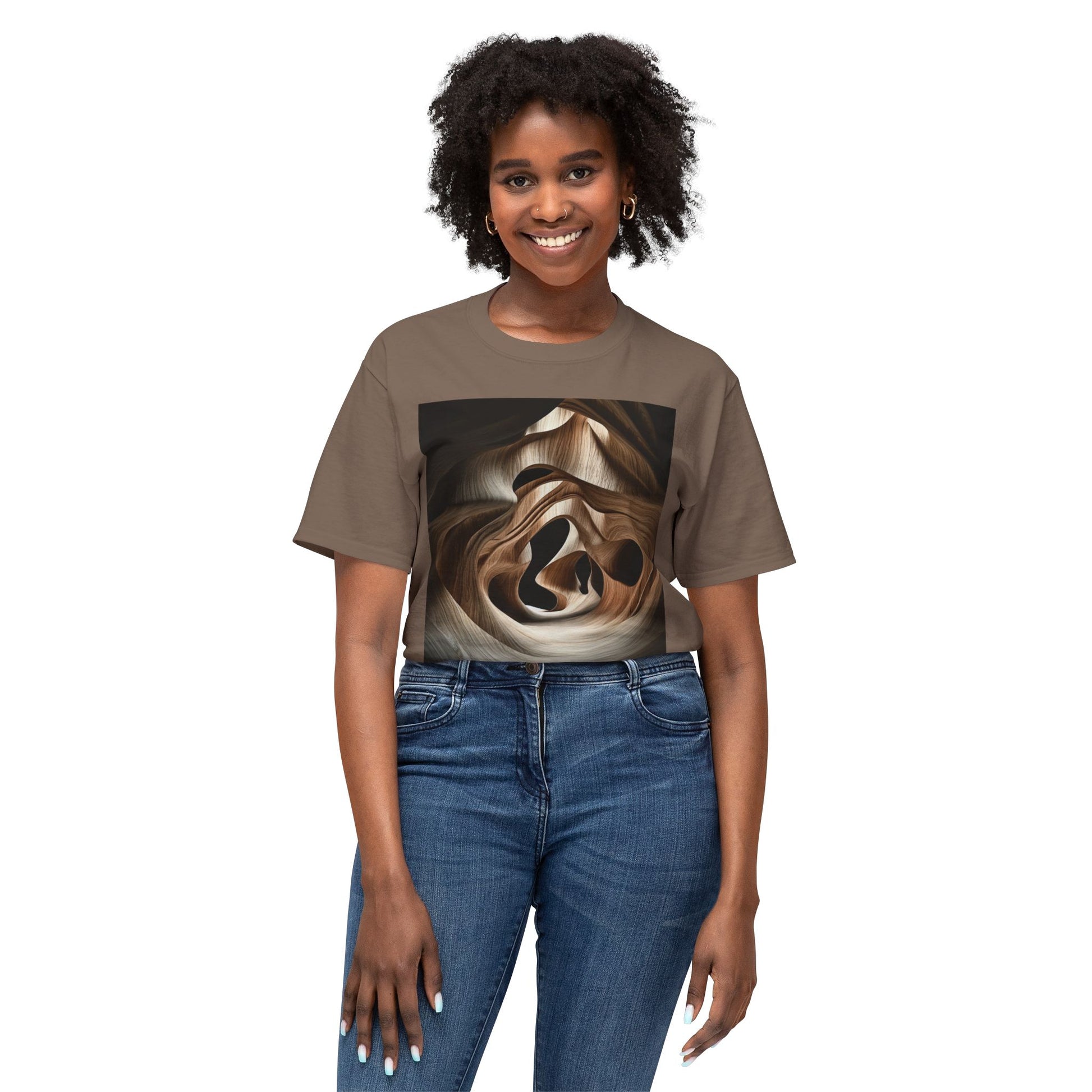 A curly-haired woman wearing a Safari-colored T-shirt with an abstract, wave-like wood grain pattern.
